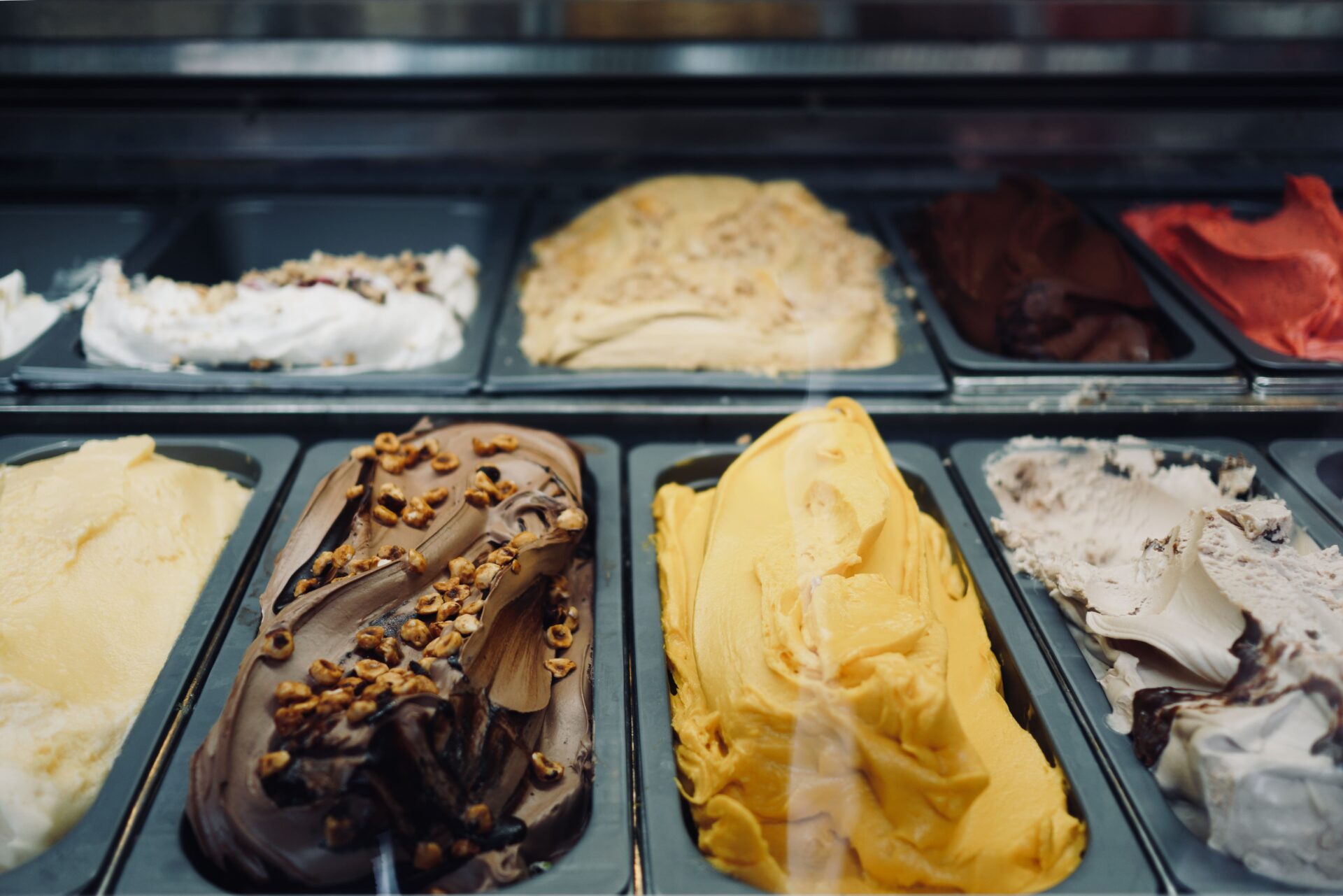 A tray of several different ice cream flavors.