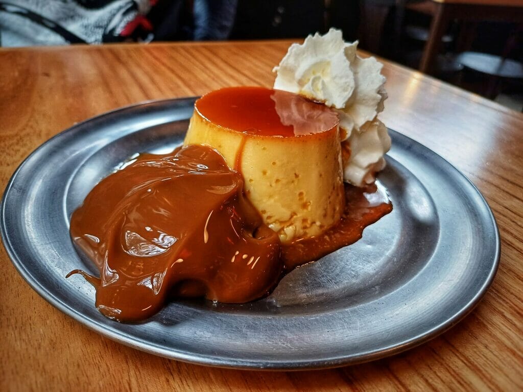 Flan with dulce de leche and whipped cream.