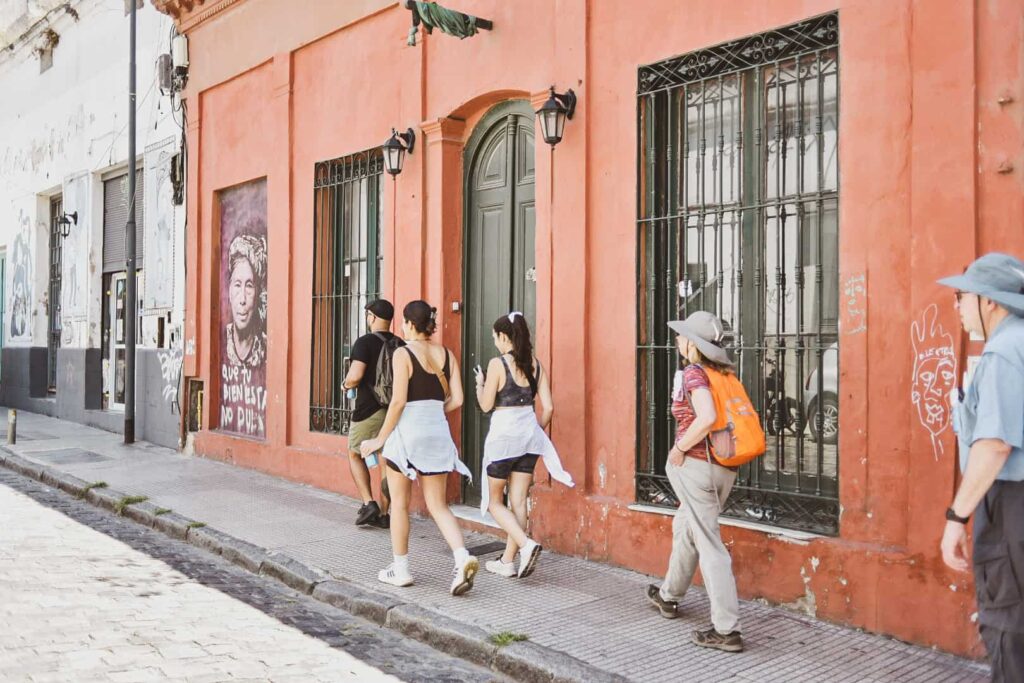 People of different ages walking along an unknown street in San Telmo.