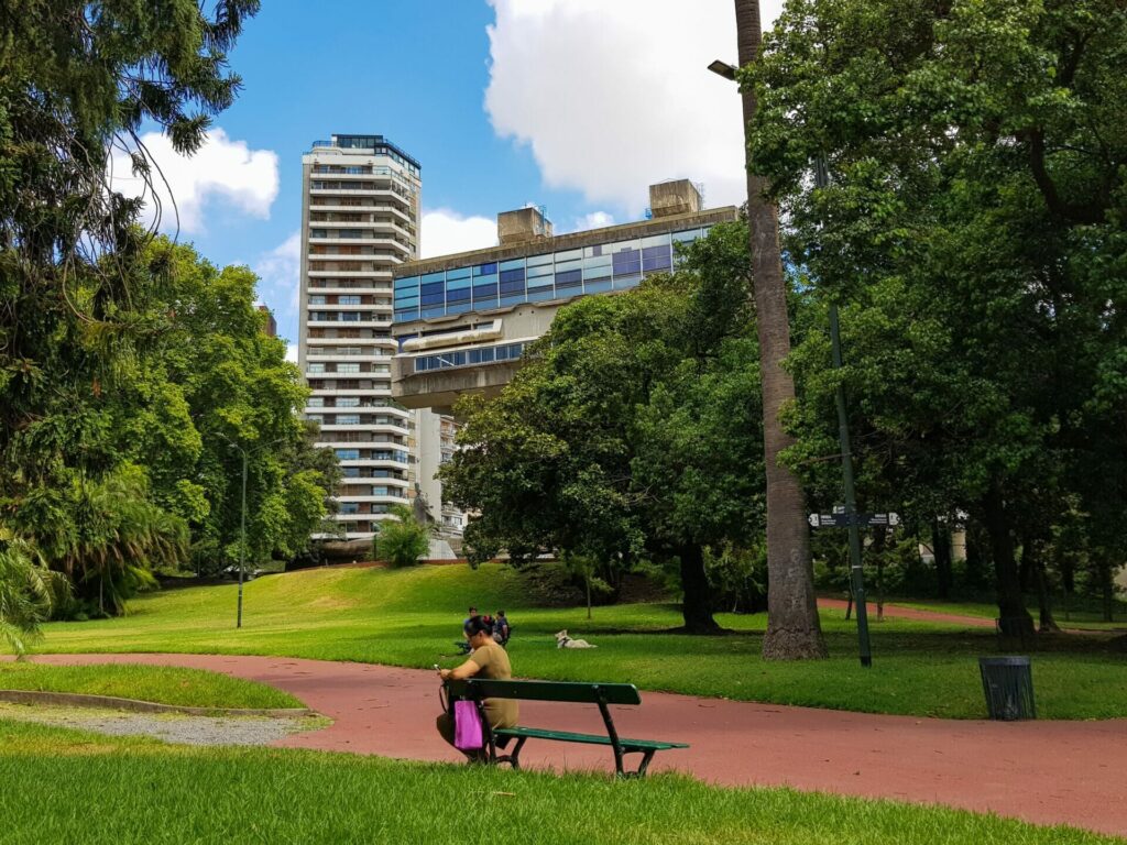 View of Argentina's National Library from the park, partially obscured by trees.