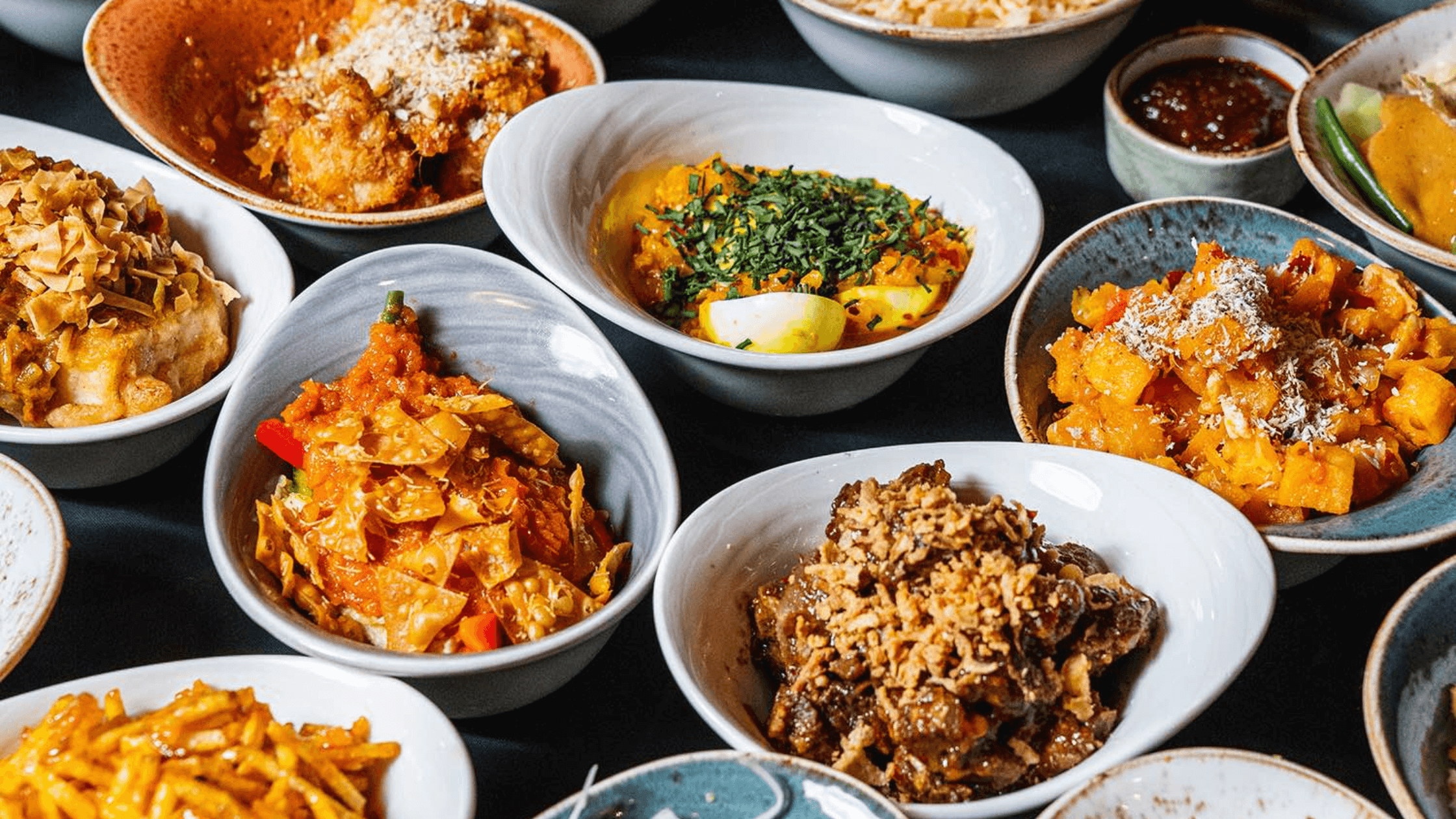 A feast of Indonesian dishes served with rice, and the Dutch word for "rice table".